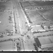 Aerial view of what appears to be either an informal horse show or possible horse sale with a great number of people in attendance.  The location has been identified as near intersection of Las Tunas Drive and (with what seem to be railroad tracks in center) Temple City Boulevard.  The building (we see only roof) in the lower left corner is Vernon's Pharmacy.  The letters VGS can be seen over front entry.  There are probably about 100 autos parked nearby. (There is another photo of this event, #539.)