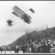 Photo of Louis Paulhan flying his Farman plane on its return to Aviation Park after setting an air distance record by flying to circle the Baldwin Ranch and returning to Dominguez Hills. This photograph belongs to the Huntington Library. It is shown here for research only.