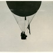 Only photo in Library Collection showing Free balloon training at Ross Field (all other are fixed).  Balloon is some distance off the ground and displays an American flag on the right side.