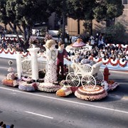 "Sunday in the Park," Arcadia's float entry in the 1986 Pasadena Tournament of Roses Parade, features a Victorian family enjoying a walk in the park.  The parents push a perambulator with  the Arcadia Rose Court.