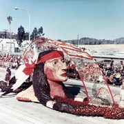 "The First Americans," Arcadia's float entry in the 1975 Pasadena Tournament of Roses Parade.  A bust of an unnamed American Indian dominates this tribute.  Surrounding the sculpture is a copy of an Indian belt.  The Indian head was the largest facial sculpture in Rose Parade history at that time.