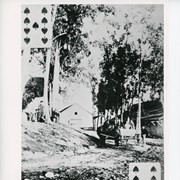 This is another of the backs of the Baldwin playing cards.  Shows the winery.  Also in photo, two horses hitched to a wagon.  People in wagon and also sitting and standing nearby.