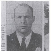 Photo of Arcadia Police Chief Don Ott, reproduced from an old Arcadia newspaper. He is in uniform with white shirt and tie.