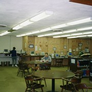 Phase I of Library Renovation/Expansion Project at 20 W. Duarte Road.  This view is of the temporary reference area, looking toward the hallway leading into the adult reading room and circulation area.  A man is seated at a table and a woman is standing at the computerized catalog.