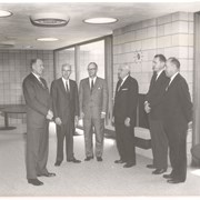 Six unidentified men, probably Council members, at dedication of the new Arcadia Public Library building at 20 W. Duarte Road.  They are standing in a semi-circle by the fireplace.