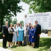 Groundbreaking ceremonies for the remodel/expansion project at Arcadia Public Library, 20 W. Duarte Road.  This photo shows a group of people standing in front of a large sign announcing the expansion project.  There is a shovel in the ground in front of them.  L-R: Kent Ross, Joan Scott, Mavis Dumbacher, Don Swenson, June Fee, Sheng Chang, Jesse Vanlandingham, Mary Young, Barbara Kuhn and Mayor Dennis Lojeski.