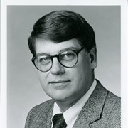Photo of Arcadia Author William K. Summers, M.D.  He is shown wearing a suit and tie.