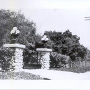 Stone pillars on either side of entrance to Clara Baldwin Stocker's home on Foothill Blvd.  Each stone pillar has a light fixture on top with a number of white globes.