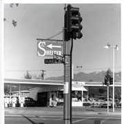 Intersection of Baldwin Ave. and Duarte Road, looking toward a Union Oil Service Station.  A traffic signal in visible in the front middle of the photo.  There is a sign with an arrow which reads SHELTER.