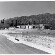 Side and back view of the yet unfinished Arcadia Police Department and its parking lot at 250 W. Huntington Drive. View of the San Gabriel Mountains is clear in the background.