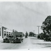 View east on Huntington Drive from intersection with First Avenue.  In the distance can be seen a railroad crossing marker which was for the Santa Fe Line (which is now serviced with an overpass of Huntington Dr.).  Building at extreme left is Bank of Italy Building on N.E. corner of First and Huntington Dr.