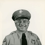 Portrait of Arcadia Police Officer Thomas G. Bednark, in uniform (hat, badge, necktie, patch).