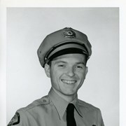 Portrait of Arcadia Police Officer William Billing, in uniform (hat, badge, necktie, patch).