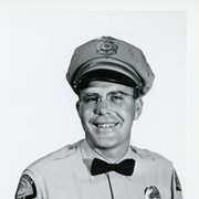 Portrait of Arcadia Police Officer Richard Chatwin, in uniform (hat, badge, bowtie, patch).