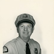 Portrait of Arcadia Police Officer Herman Decker, in uniform, (hat, badge, necktie, patch).