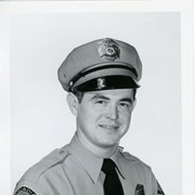 Portrait of Arcadia Police Officer Maurice Farr, in uniform (hat, badge, necktie, patch).