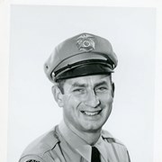 Portrait of Arcadia Police Officer Paul Harrington, in uniform (hat, badge, necktie, patch).