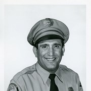 Portrait of Arcadia Police Department Officer Joseph Ocello, in uniform, (hat, badge, tie, patch).