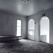 Interior of mansion, showing second story room with a long table The arched doorway with the exit sign above it seems to be leading downstairs. Former home of Prince Erik of Denmark in 1920s at 2607 S. Santa Anita Avenue. Built in 1924. Property now owned by Arcadia Congregational Church. Photograph by Terry Miller.
Note: Per Jolene Cadenbach, a fire destroyed Prince Erik Hall in June 2021, tear down started around end of 2021, and was completely torn down in 2022.