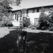 Exterior of mansion, showing backyard. Middle of photo shows a drinking fountain in the shade. Former home of Prince Erik of Denmark in 1920s at 2607 S. Santa Anita Avenue. Built in 1924. Property now owned by Arcadia Congregational Church. Photograph by Terry Miller. See also ID 2193.