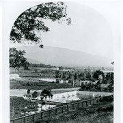 View east from center of Baldwin Ranch.  Concrete type reservoir in foreground.  The lagoon is in center of photo. White barns on the knoll in center of photo. View similar to photo #143. This photograph belongs to the Huntington Library. It is shown here for research only.