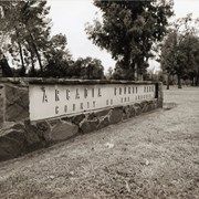 Slightly skewed view of the sign at the fountain near the southwest corner of Santa Anita Avenue and Huntington Drive reads: Arcadia County Park, County of Los Angeles. This was before peacock sculpture was added to the fountain. Later known as Peacock Fountain. Photograph by Terry Miller.