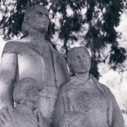 Closer up view of Hugo Reid Family statue, showing the faces of the family, at Arcadia County Park. Swings are in the background. This was before the statue was moved to the Gilb Museum. Photograph by Terry Miller.