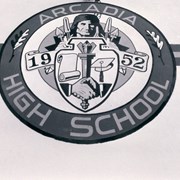 Arcadia High School logo crest painted on the wall of the school. Shows Apache mascot and "1952." Photograph by Terry Miller.
