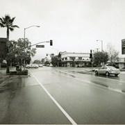Downtown Arcadia intersection of Huntington Drive and First Avenue. There is a three-story building on the northwest corner, Washington Mutual bank on the southwest corner (barely visible), a Chevron gas station on the southeast corner, and cars on the street. This same corner was once the location of Arcadia City Hall. Photo by Terry Miller.