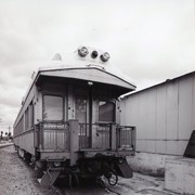 Another back view of abandoned caboose of a train. Train is marked with Pine Bluff SP 151 (clearer in photo 2258A). Looking northeast on train tracks near First Avenue, between Santa Clara Street and Saint Joseph Street in Arcadia, California. Photo by Terry Miller.