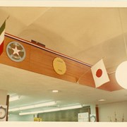 Children's Room, Arcadia Public Library, 20 W. Duarte Rd. decorated for Summer Reading Club with 1968 Summer Olympics theme, featuring flags and emblems of various nations. Shows interior architectural details such as arched ceiling, recessed lighting, globe pendant lights and other lighting.