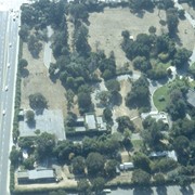 Aerial view, of Anita M. Baldwin's former estate known as Anoakia, looking west. Address was at 701 West Foothill Boulevard in Arcadia, when it was the Anoakia School. Street on the left is Foothill Boulevard? Gatehouse in the lower left corner? Any use of this image must be credited "Photograph by David Stevens. Copyright David Stevens."