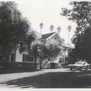 View of front drive and entry of Clara Baldwin home, reported to have been built in 1906, located at 291 W. Foothill Boulevard.  Station wagon parked in front.
