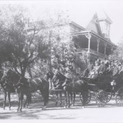 Side view photo of Oakwood Hotel with a Tally Ho stopped here with its full party. Hotel was built in 1889 and was situated about where parking lot of the Sportsrock Cafe is now.