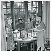 Four women standing in a bay window area of the Arcadia Public Library at 25 N. First Avenue.  Left to right: Library staff Mary Lou Harbin, Madeline Hopps, children's author Margaret Richardson, and library staff June Davies. Mrs. Richardson lived in Arcadia and wrote SEVEN LITTLE PIFFLESNIFFS.