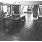 View of library at Anoakia looking toward entry and dining room.  Tile floor, possibly made by Ernest Batchelder.  Tiffany light fixture.