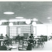 View of south portion of adult reading area and south patio.  The screen was made of brown styrofoam balls suspended from ceiling. Mid-century style. Arcadia Public Library.