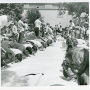 Large group of youngsters are engaged in a watermelon eating contest while some of Recreation Department personnel keep eye on proceedings.