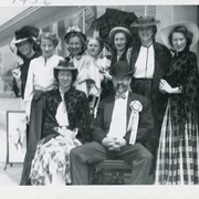 Photo of nine people dressed in costumes of 1890's for Peach Blossom Festival.  Identification on back of photo.