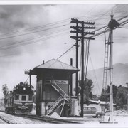 Pacific Electric control tower near First Street and Santa Fe tracks.  The car on the tracks probably is one of the Santa Fe self-propelled cars that ran from Los Angeles to San Bernardino.  View to the northwest.
