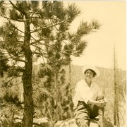 Nell Schrader in hiking attire pictured sitting on a boulder in mountains north of Arcadia.  She was wife of member of City Council in 1930's, Walter Schrader.