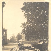 Photo showing wrecked automobile and a portion of the control tower alongside tracks near First Avenue and railroad crossing.  Information on back of photo identifies it as Ben Newman's wrecked Buick hit by Santa Fe train.