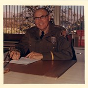 Police Chief Orr, seated at his desk in his uniform.  He was Chief from 1942-1944 and again 1951-1956.