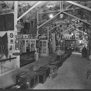  Interior of Pony Express Museum, collections. View very similar to Item ID 455, but apparently at a different time. While row of trunks in center of long room are the same, displays on either side are different. On far wall in this photo is a sign reading Jamestown.