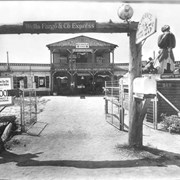 View showing main entrance to Pony Express Museum.  Sign on extreme left reads: This building moved from the old mining town of Bear Valley...etc. There is a sign designating entrance and indicating 25 cent fee.  On right side of photo is shown a Black man carved which may have been a mast head of a ship.