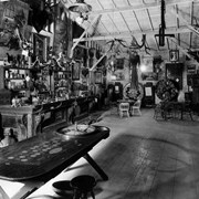 View of bar and gambling facilities in one section of Pony Express Museum. Neither the bar nor the gaming equipment were in use, but were displays like all else.  Photo shows roulette table in foreground, the bar on left side of photo, wheels of chance and two tables with chairs at back wall.