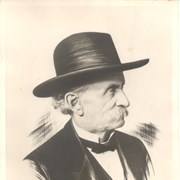 Formal portrait of Elias J."Lucky"Baldwin.  He is shown in black hat and facing to the right.  Portions of photo look touched up.
