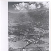 Aerial view taken from about over what became Campus Drive and Arcadia High School, and looking toward (NW) Pasadena and Sierra Madre at foot of San Gabriel Mountains.  Photo shows Santa Anita Park Race Track possibly just a few years after opening.