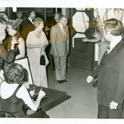 Rev. Paul Johenk, Chaplain at Arcadia Methodist Hospital, is shown in a slight bow toward a lady who is out of view.  About ten other people are seen nearby in this photo taken at Diamond Jubilee Ball.