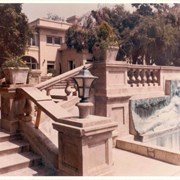 View up front stairs at Anoakia, with balustrade to front entrance.  Bas relief above pond. Note: inscription on back of photo done by Eunice Easley, secretary to Lowry McCaslin.
